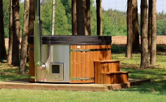 Thermowood-clad hot tub with steps in a woodland setting