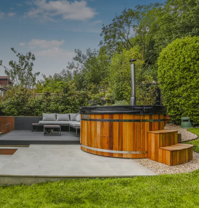 Cedar wood-fired hot tub on a garden patio