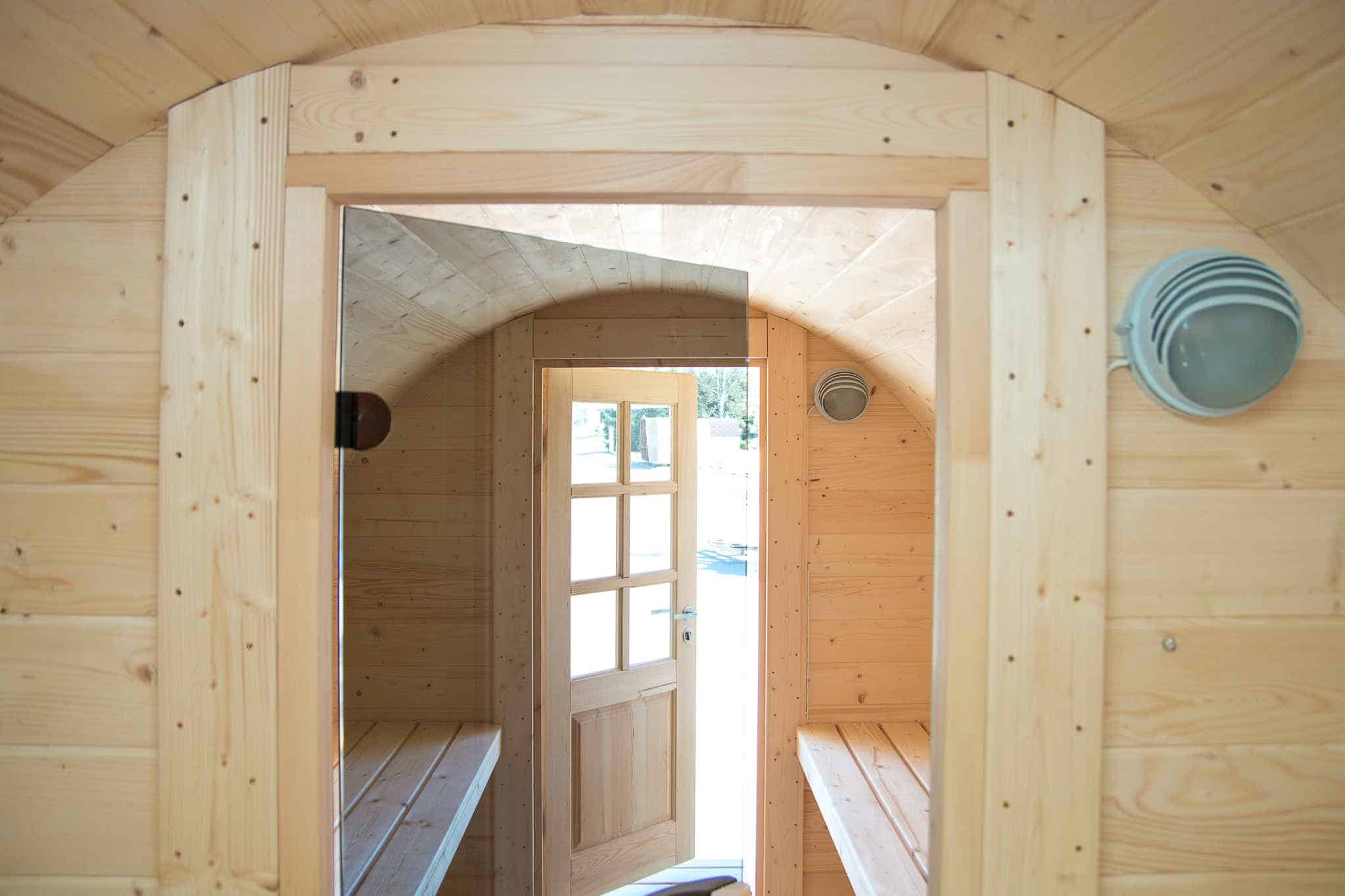 Looking through the door of a Royal Tubs barrel sauna to the benches inside